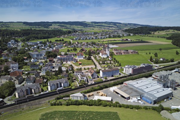 View of the village with the catholic parish church Mariä Geburt, on the right the industrial area, behind the Lindenberg, Sins, Freiamt, Canton, Aargau, Switzerland