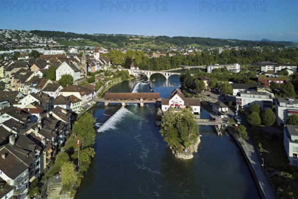 Old town with the tower of the Muri- Amthof, in the centre the weir and the old wooden bridge crossing the river Reuss, on the right the museum Reusskraftwerk Bruggmühle, Bremgarten, Freiamt, Canton, Aargau, Switzerland