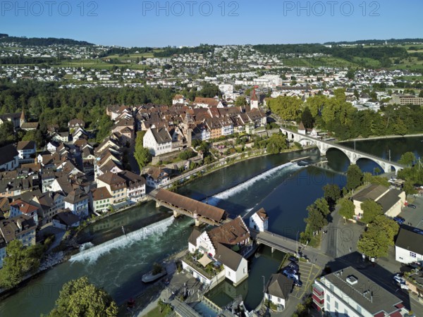 Old town with the tower of the Muri- Amthof, in the foreground the weir, the museum Reusskraftwerk Bruggmühle and the old wooden bridge crossing the river Reuss, Bremgarten, Freiamt Canton Aargau, Switzerland