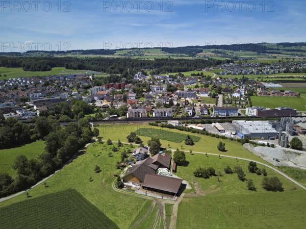 View of the village with the Catholic parish church Mariä Geburt, on the right the industrial area, behind the Lindenberg, Sins, Freiamt, Canton Aargau, Switzerland