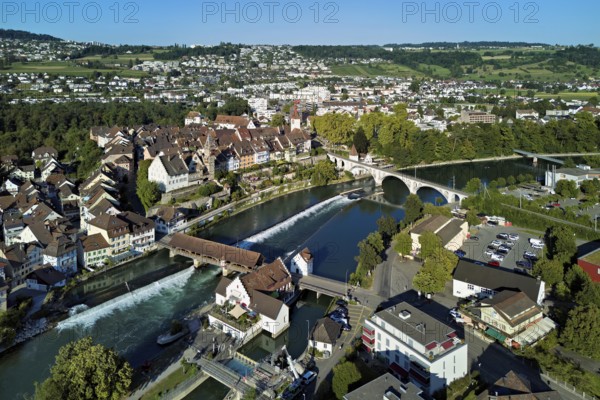 Old town with the tower of the Muri- Amthof, in the foreground the weir, the museum Reusskraftwerk Bruggmühle and the old wooden bridge crossing the river Reuss, Bremgarten, Freiamt Canton Aargau, Switzerland
