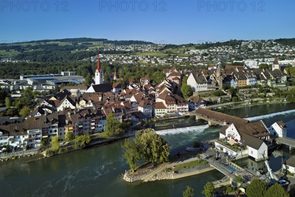 Old town with the Catholic Church of St Nicholas and the tower of the Muri- Amthof, in the foreground the weir and the museum Reusskraftwerk Bruggmühle on the river Reuss, Bremgarten, Freiamt, Canton, Aargau, Switzerland