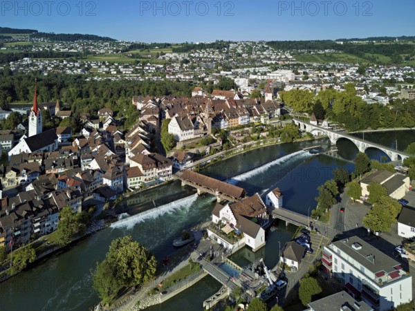 Old town with the Catholic Church of St Nicholas and the tower of the Muri- Amthof, in the foreground the weir and the museum Reusskraftwerk Bruggmühle on the river Reuss, Bremgarten, Freiamt, Canton, Aargau, Switzerland