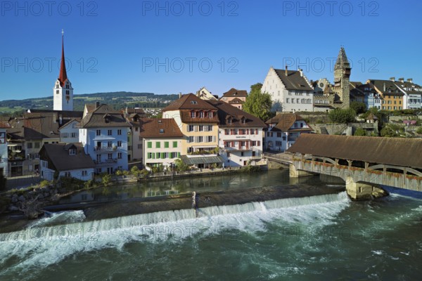 Old town with the Catholic Church of St Nicholas and the tower of the Muri- Amthof, in the foreground the weir, the old wooden bridge over the river Reuss, Bremgarten, Freiamt, Canton, Aargau, Switzerland