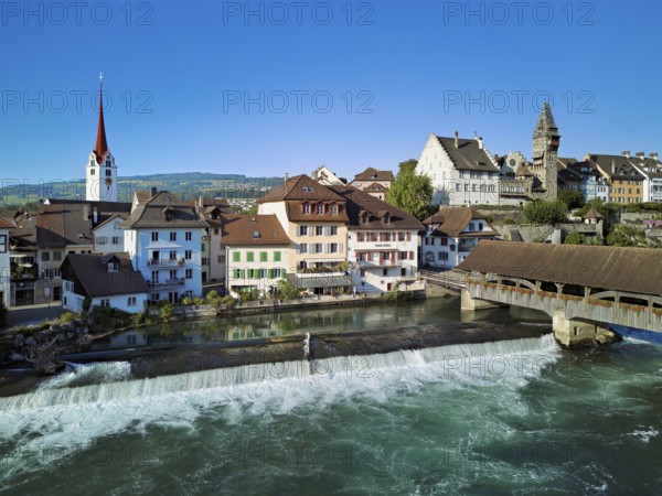 Old town with the Catholic Church of St Nicholas and the tower of the Muri- Amthof, in the foreground the weir, the old wooden bridge over the river Reuss, Bremgarten, Freiamt, Canton, Aargau, Switzerland