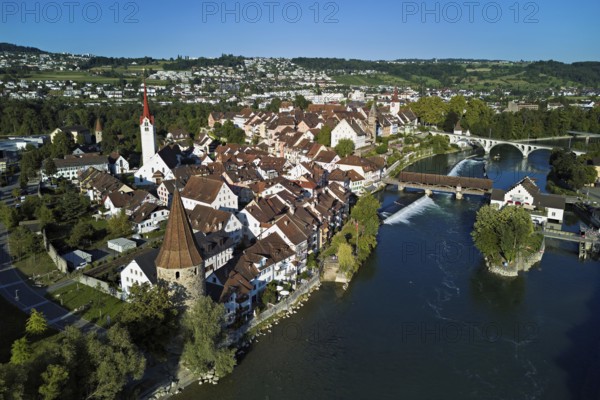 Old town with the Catholic Church of St. Nicholas, the tower of the Muri- Amthof and the witches' tower, on the right the Museum Reusskraftwerk Bruggmühle and the old wooden bridge over the river Reuss, Bremgarten, Freiamt, Canton, Aargau, Switzerland