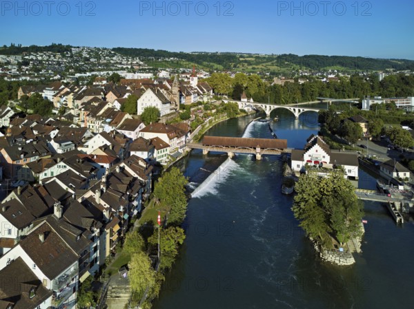 Old town with the tower of the Muri- Amthof, in the centre the weir and the old wooden bridge crossing the river Reuss, on the right the museum Reusskraftwerk Bruggmühle, Bremgarten, Freiamt, Canton, Aargau, Switzerland