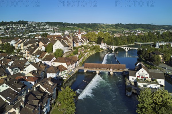 Old town with the tower of the Muri- Amthof, in the centre the weir and the old wooden bridge crossing the river Reuss, on the right the museum Reusskraftwerk Bruggmühle, Bremgarten, Freiamt, Canton, Aargau, Switzerland