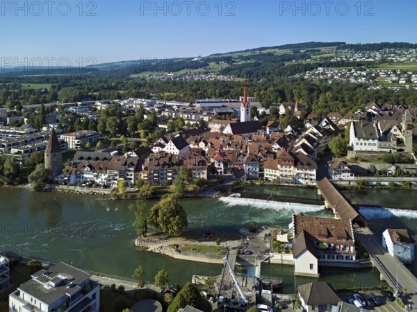 Old town with the Catholic church of St Nicholas and the witches' tower and the tower of the Muri- Amthof, in the foreground the weir and the old wooden bridge over the river Reuss, Bremgarten, Freiamt, Canton, Aargau, Switzerland