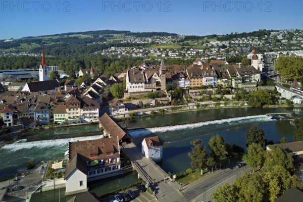 Old town with the Catholic Church of St Nicholas and the tower of the Muri- Amthof, in the foreground the weir and the old wooden bridge over the river Reuss, Bremgarten, Freiamt, Canton, Aargau, Switzerland
