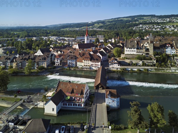 Old town with the Catholic Church of St Nicholas and the tower of the Muri- Amthof, in the foreground the weir and the old wooden bridge over the river Reuss, Bremgarten, Freiamt, Canton, Aargau, Switzerland