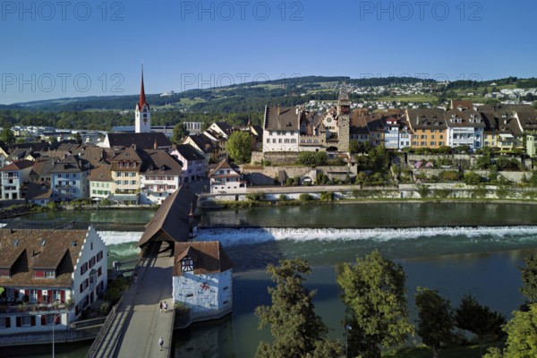 Old town with the Catholic Church of St Nicholas and the tower of the Muri- Amthof, in the foreground the weir and the old wooden bridge over the river Reuss, Bremgarten, Freiamt, Canton, Aargau, Switzerland