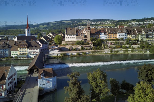 Old town with the Catholic Church of St Nicholas and the tower of the Muri- Amthof, in the foreground the weir and the old wooden bridge over the river Reuss, Bremgarten, Freiamt, Canton, Aargau, Switzerland