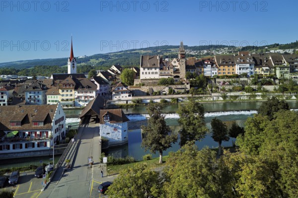 Old town with the Catholic Church of St Nicholas and the tower of the Muri- Amthof, in the foreground the upper weir and the old wooden bridge over the river Reuss, Bremgarten, Freiamt, Canton, Aargau, Switzerland