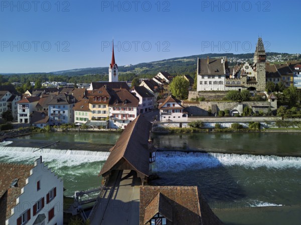 Old town with the Catholic Church of St Nicholas and the tower of the Muri- Amthof, in the foreground the weir and the old wooden bridge over the river Reuss, Bremgarten, Freiamt, Canton, Aargau, Switzerland