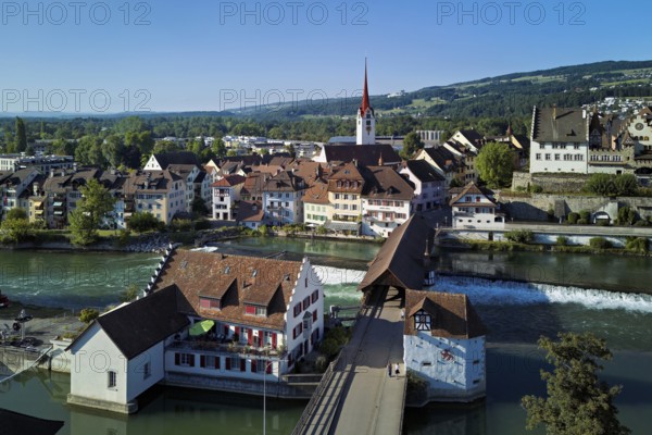 Old town with the Catholic Church of St Nicholas and the Witches' Tower, in the foreground the Museum Reuskraftwerk Bruggmühle and the old wooden bridge over the river Reuss, Bremgarten, Freiamt, Canton, Aargau, Switzerland