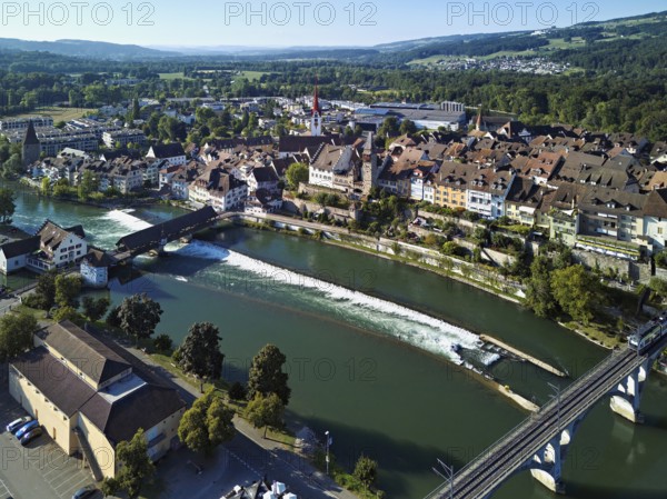 Old town with the Catholic Church of St Nicholas and the witches' tower, in the foreground the upper weir and the old wooden bridge over the river Reuss, Bremgarten, Freiamt, Canton, Aargau, Switzerland