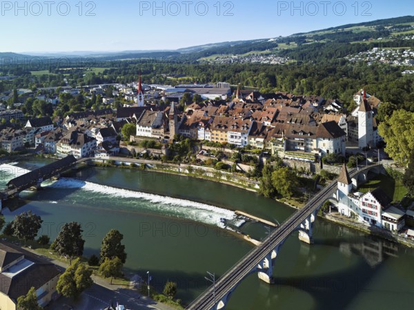 Old town with the Catholic Church of St. Nicholas and the tower of the Muri- Amthof, in the foreground the upper weir and the railway bridge over the river Reuss, Bremgarten, Freiamt, Canton, Aargau, Switzerland