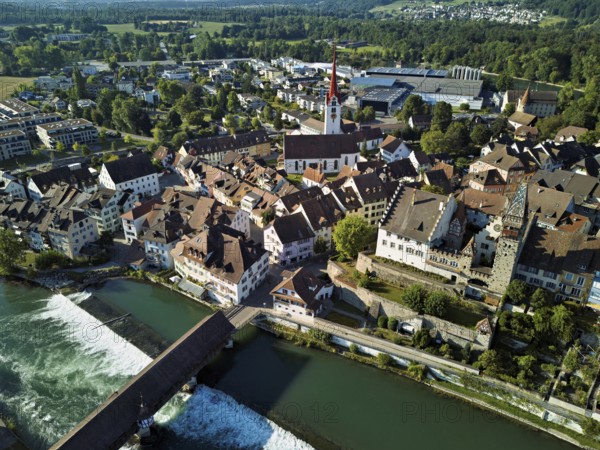Old town with the Catholic Church of St Nicholas and the tower of the Muri- Amthof, in the foreground the upper weir and the old wooden bridge over the river Reuss, Bremgarten, Freiamt, Canton, Aargau, Switzerland