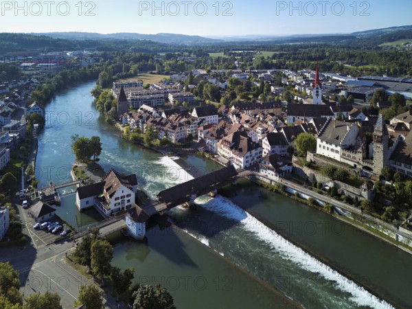 Old town with the Catholic Church of St Nicholas and the tower of the Muri- Amthof, in the foreground the upper weir and the old wooden bridge over the river Reuss, Bremgarten, Freiamt, Canton, Aargau, Switzerland