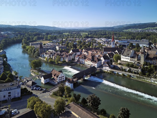 Old town with the Catholic town church of St Nicholas and the witches' tower and the tower of the Muri- Amthof, in the foreground the upper weir and the old wooden bridge over the river Reuss, Bremgarten, Freiamt, Canton, Aargau, Switzerland