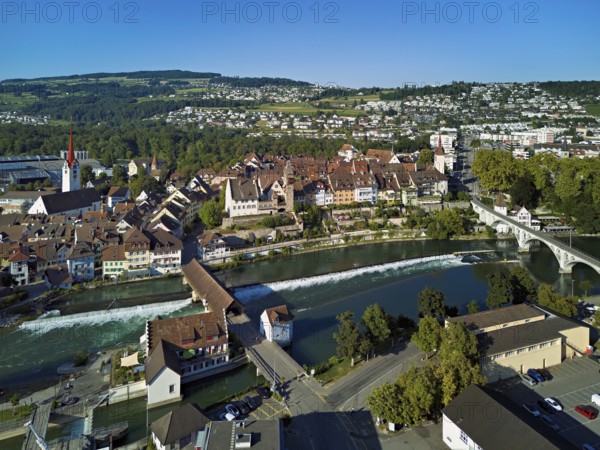 Old town with the Catholic Church of St Nicholas and the tower of the Muri- Amthof, in the foreground the weir and the old wooden bridge over the river Reuss, Bremgarten, Freiamt, Canton, Aargau, Switzerland