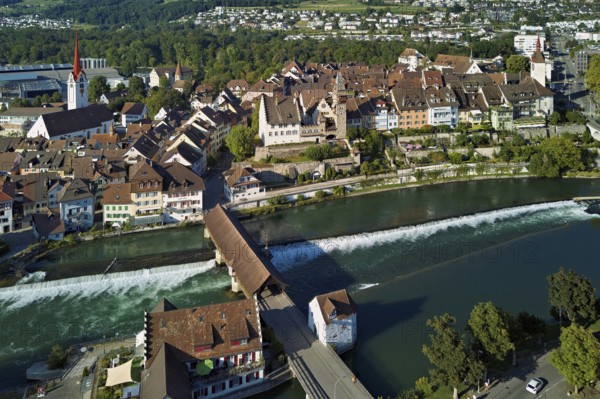Old town with the Catholic Church of St Nicholas and the tower of the Muri- Amthof, in the foreground the weir and the old wooden bridge over the river Reuss, Bremgarten, Freiamt, Canton, Aargau, Switzerland