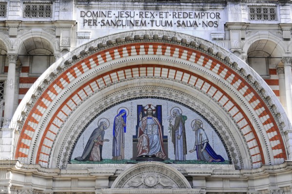 Partial view of Westminster Cathedral, London, England, Great Britain, Europe, Detailed mosaic with religious symbols and depiction of Christ under a decorative arch, London region