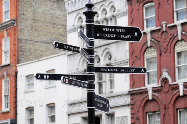 London, England, Great Britain, Europe, Several black signposts in London in front of Victorian buildings