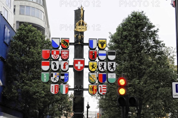London, England, Great Britain, Europe, City signs with coats of arms and a traffic light in the background under a grey sky