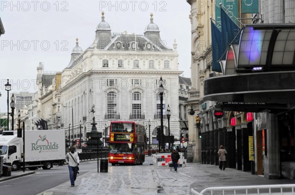 London, England, Great Britain, Europe, Red double-decker bus in a city street in front of historic architecture