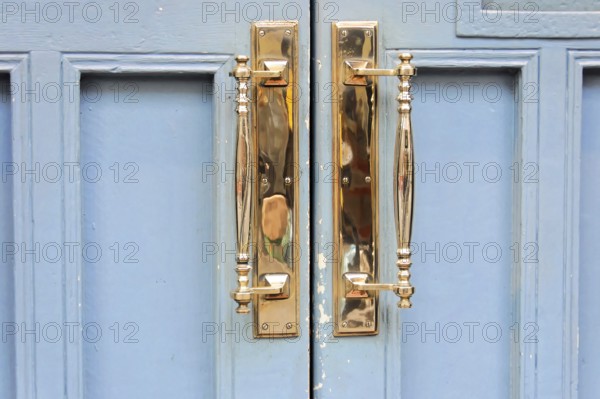 London, England, Great Britain, Europe, Close-up of golden door handles on a blue door