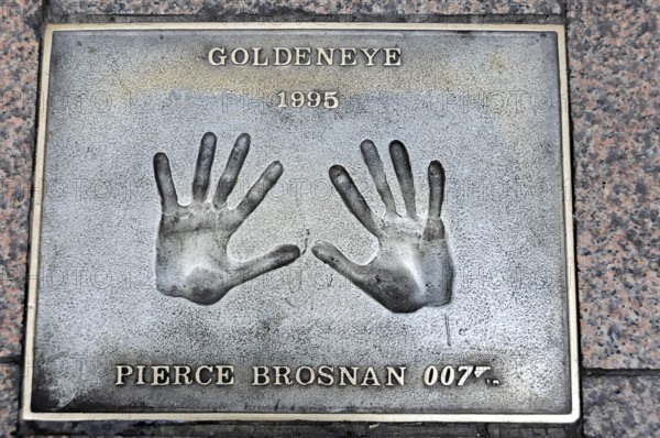 Handprints of Pierce Brosnan for the film GoldenEye on a metal plate on the pavement, London, England, Great Britain
