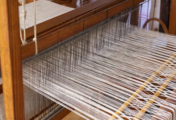 Closeup shot of a historic wooden loom with threads