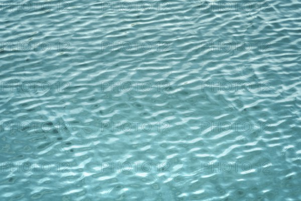 Full frame abstract light blue ripply water surface