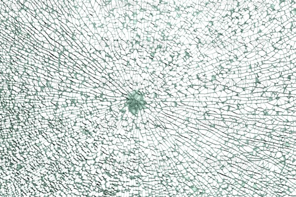 Full frame shot of a broken safety glass pane in white back