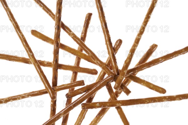 Closeup of some crossed salt sticks in white back