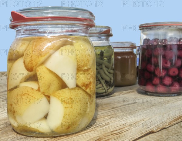 Closeup shot of somesome preserving bottles filled with fruits