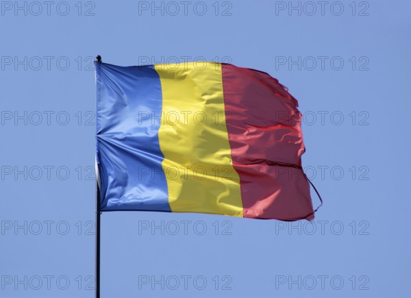 Romanian flag in front of blue sky