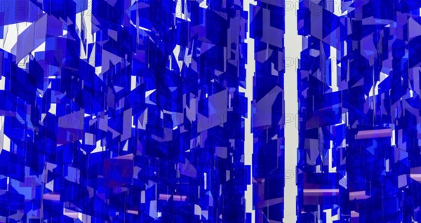 Full frame abstract background showing lots of hanging blue glass sheets