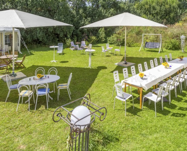 Sunny illuminated idyllic scenery showing a garden prepared for party