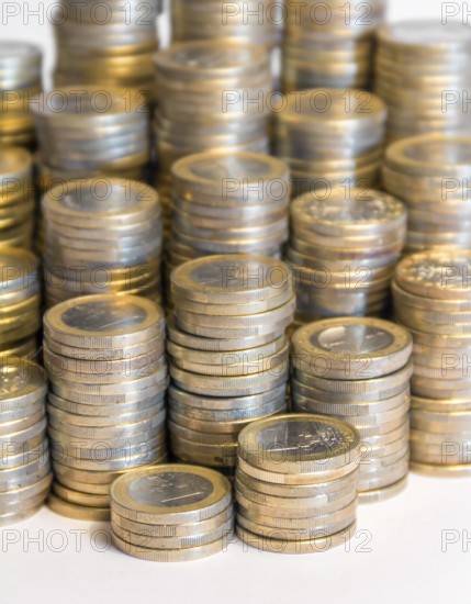 Lots of stacked 1 euro coins