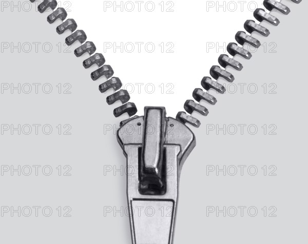 Studio photography showing the detail of a zipper in light back