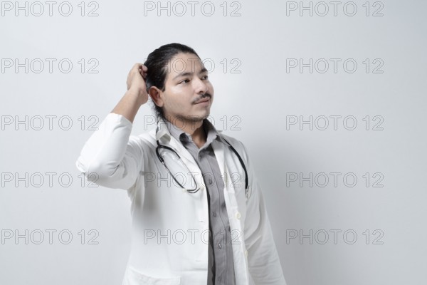 Young doctor scratching his head