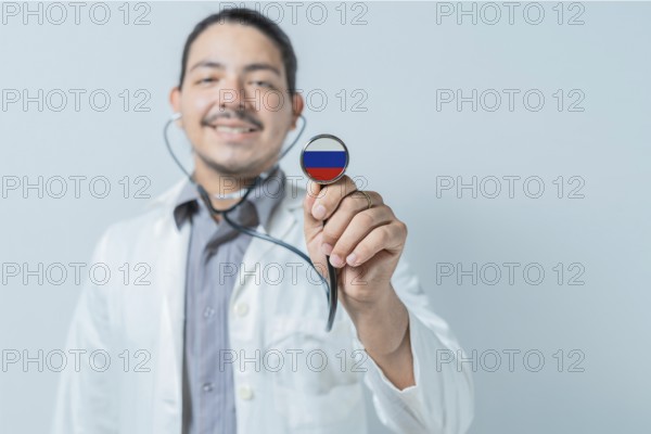 Smiling doctor showing stethoscope with Russia flag. Russia national healthcare