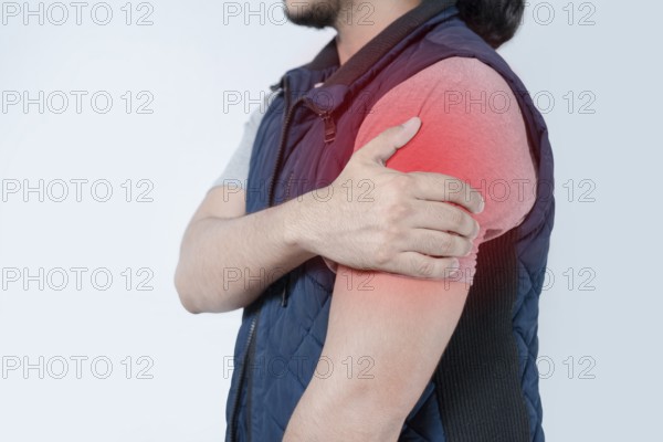 Unrecognizable person with shoulder pain on isolated. Person in pain with arm pain highlighted in red on isolated