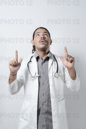 Shocked doctor looking up on isolated