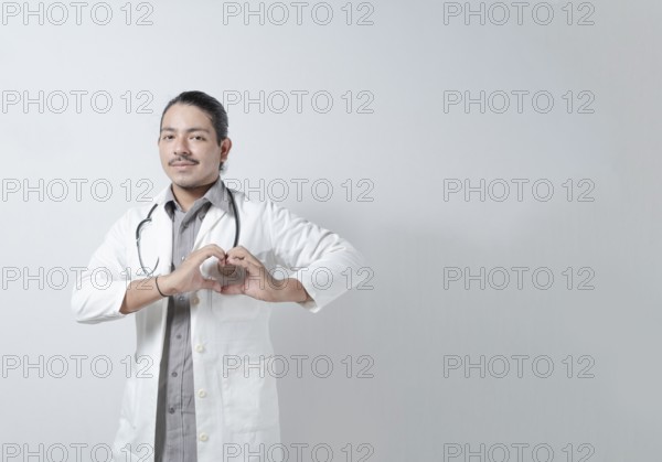 Young doctor heart hand in stethoscope