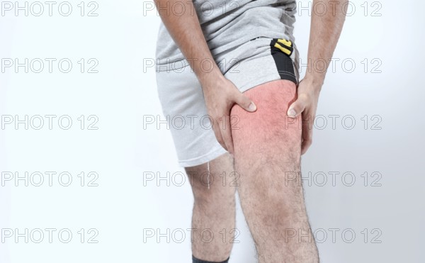 Closeup of sore knee on isolated background. Male holding his knee in pain on isolated