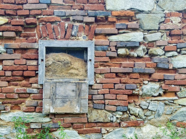 Weathered brick wall with wooden box and natural stones, gives a rustic impression Styria Austria